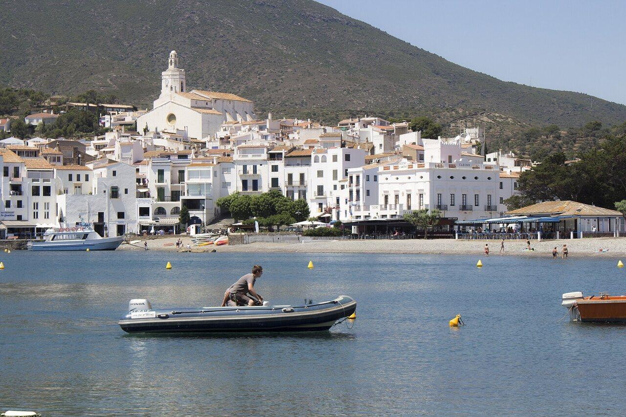 Small boats moored in front of Cadaqués and the white church of Santa Maria