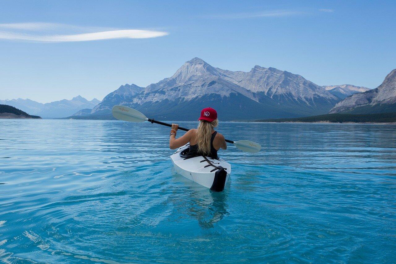 Kayaker practicing paddle technique on calm water